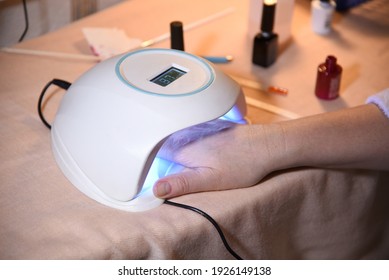 Female Hand In The Device Lamp For Drying Nails With Ultra Violet Rays