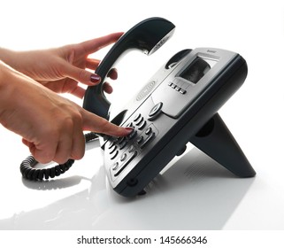 Female Hand Dialing A Phone Number With Picked Up Headset