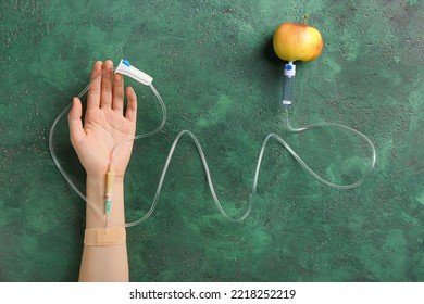 Female Hand With Dropper And Apple On Color Background. Anorexia Concept