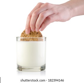 Female Hand Dunking Cookie In Milk, Isolated On White.