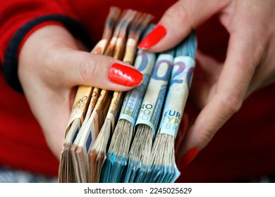 Female hand with  a lot of euro banknotes. The concept of wealth, success, greed and corruption, lust for money. 