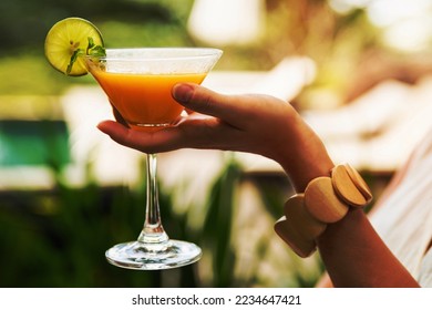 Female hand with a frozen Daiquiri cocktail oudoors