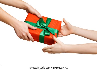 Female Hand Give Gift Box To Kid, Mother Greeting Her Child, Isolated On White Background, Close-up, Cutout. Holiday Present, Celebration Concept