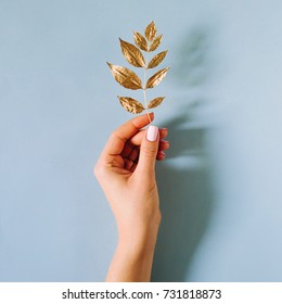 Female Hand  Hold A Golden Autumn Leaf