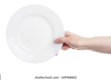 Female hand holding big white plate isolated on white background 