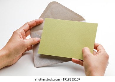 Female Hand Holding Blank Postcard And Envelope.