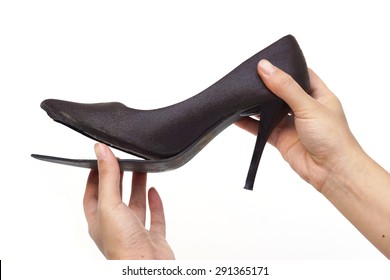 Female Hand Holding Broken High Heel Shoes