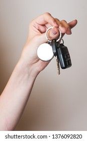 Female Hand Holding Car Key Chain