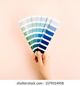 Female hand holding color swatches. Color trend palette. Flat lay, top view.  - Shutterstock ID 1579314958