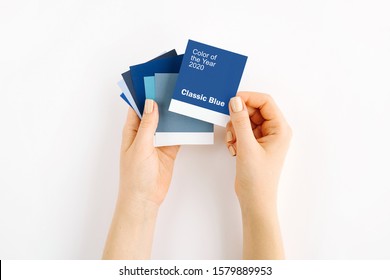 Female hand holding color of the year 2020 - Classic Blue with fashion colour swatches. Color trend palette.  - Shutterstock ID 1579889953