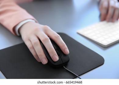 Female Hand Holding Computer Mouse On Pad