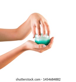 Female Hand Holding Cream Bottle Of Lotion Isolated. Girl Opening Jar Cosmetic Products On White Background.