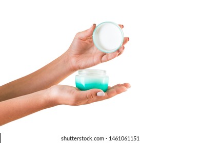 Female Hand Holding Cream Bottle Of Lotion Isolated. Girl Opening Jar Cosmetic Products On White Background.