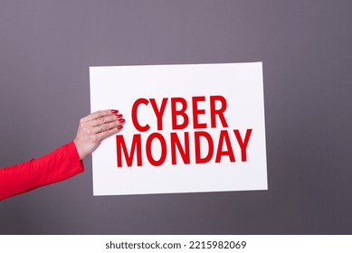 Female hand holding a cyber monday poster.