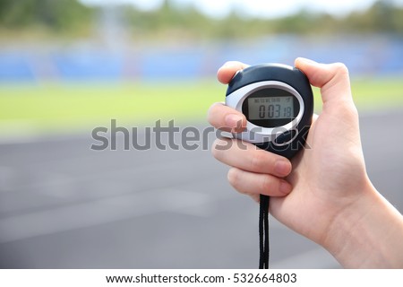 Female hand holding digital stopwatch, close up