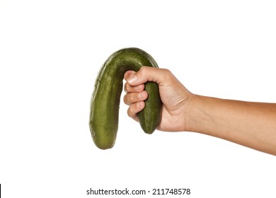 female hand holding a distorted cucumber on white background