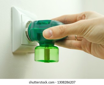 Female Hand Is Holding An Electric Insect Repellent.