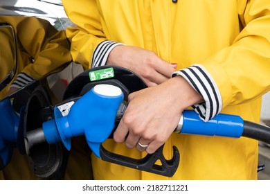 Female Hand Holding Ethanol Gun And Refueling