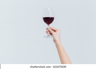 Female Hand Holding Glass With Wine Isolated On A White Background