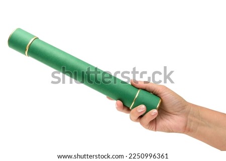 Female hand holding a green graduation straw, symbolizing graduation in a course. Diploma holder.