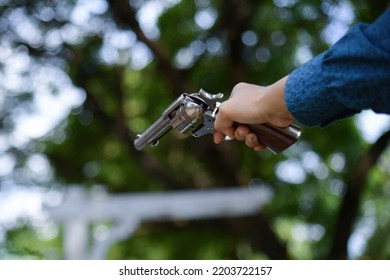 Female Hand Holding A Gun