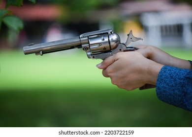 Female Hand Holding A Gun