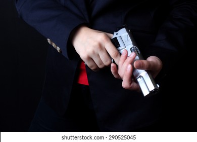 Female Hand Holding Gun With A Black Background