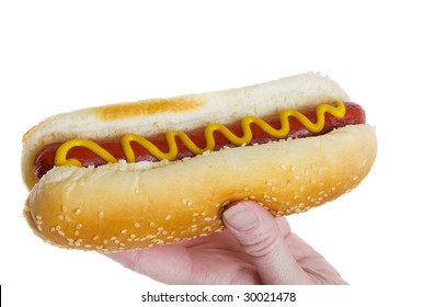 Female Hand Holding A Hot Dog Ready To Eat