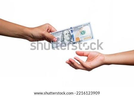 Female hand holding hundred-dollar cash bill passing it on to another person  isolated on a white background. Shopping, payment for purchases, banking operations. Money concept