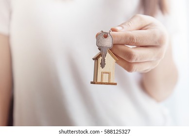 Female Hand Holding Key House Shaped Keychain.