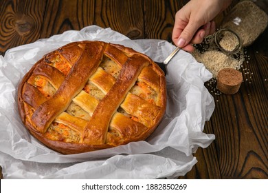 Female Hand Holding A Meat Pie
