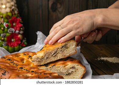 Female Hand Holding A Meat Pie
