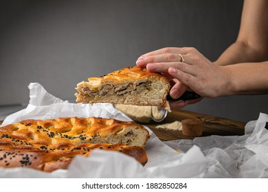 Female Hand Holding A Meat Pie
