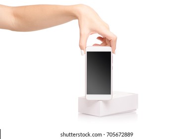 Female hand holding a mobile phone smartphone box on a white background isolation