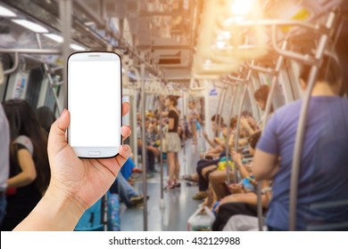 Female Hand Holding Mobile Smartphone , Tablet, Cell Phone Over Blurred Abstract Background Of People On The Transit Train In Singapore