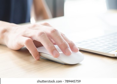 Female Hand Holding Mouse While Working On Computer