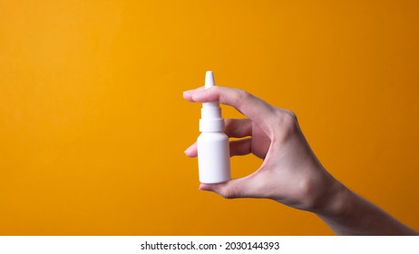 Female Hand Holding Nose Spray