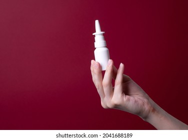 Female Hand Holding Nose Spray