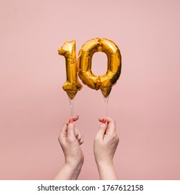 Female Hand Holding A Number 10 Birthday Anniversary Celebration Gold Balloon