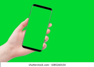 Female hand holding phone, isolated on green background - Powered by Shutterstock