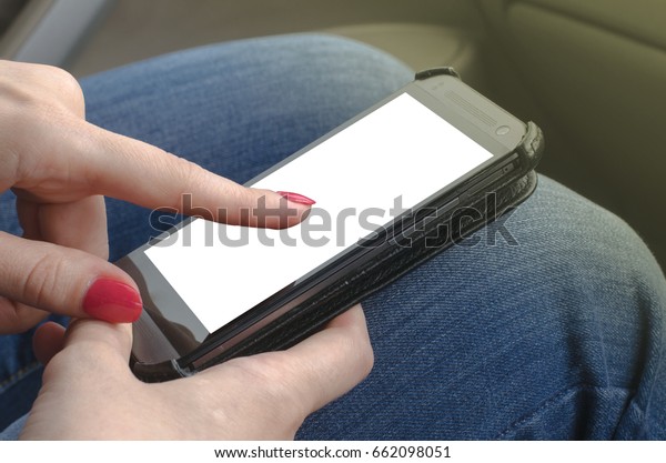 Female hand holding a\
phone. Navigation system concept. Woman point by finger on mobile\
phone screen.