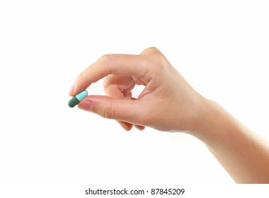 Female Hand Holding Pill Isolated