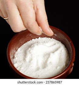 Female Hand Holding Pinch Of Salt