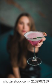 A Female Hand Holding Pink Alcoholic Strawberry Cocktail Drink With Gin, Lemonade, Champagne Or Vodka In Drink Glass For Summer Drinks