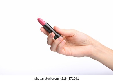 Female Hand holding pink lipstick tube isolated on white background