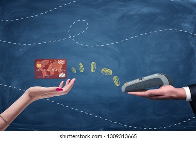 Female Hand Holding Plastic Card And Male Hand Holding Pin Pad On Blue Background. Money Transfers. Banking And Finance. Currency Transactions.