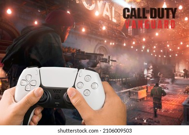 Female hand holding a Playstation 5 Dual Sense Controller with Call of Duty Vanguard game blurred in the background. Rio de Janeiro, RJ, Brazil. October 2021