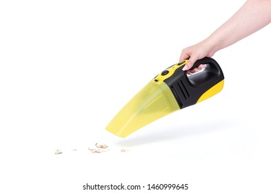Female hand holding a portable vacuum cleaner cleaning the house, isolated on white background. File contains a path to isolation.