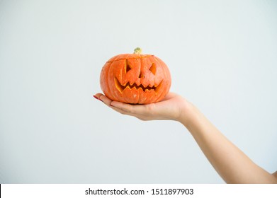 Female hand holding pumpkin