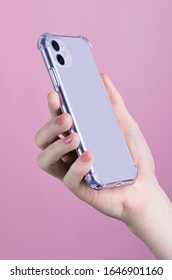 
Female Hand Holding Purple IPhone 11 Back Side View. Clear Phone Case Mock Up Isolated On Pink Background